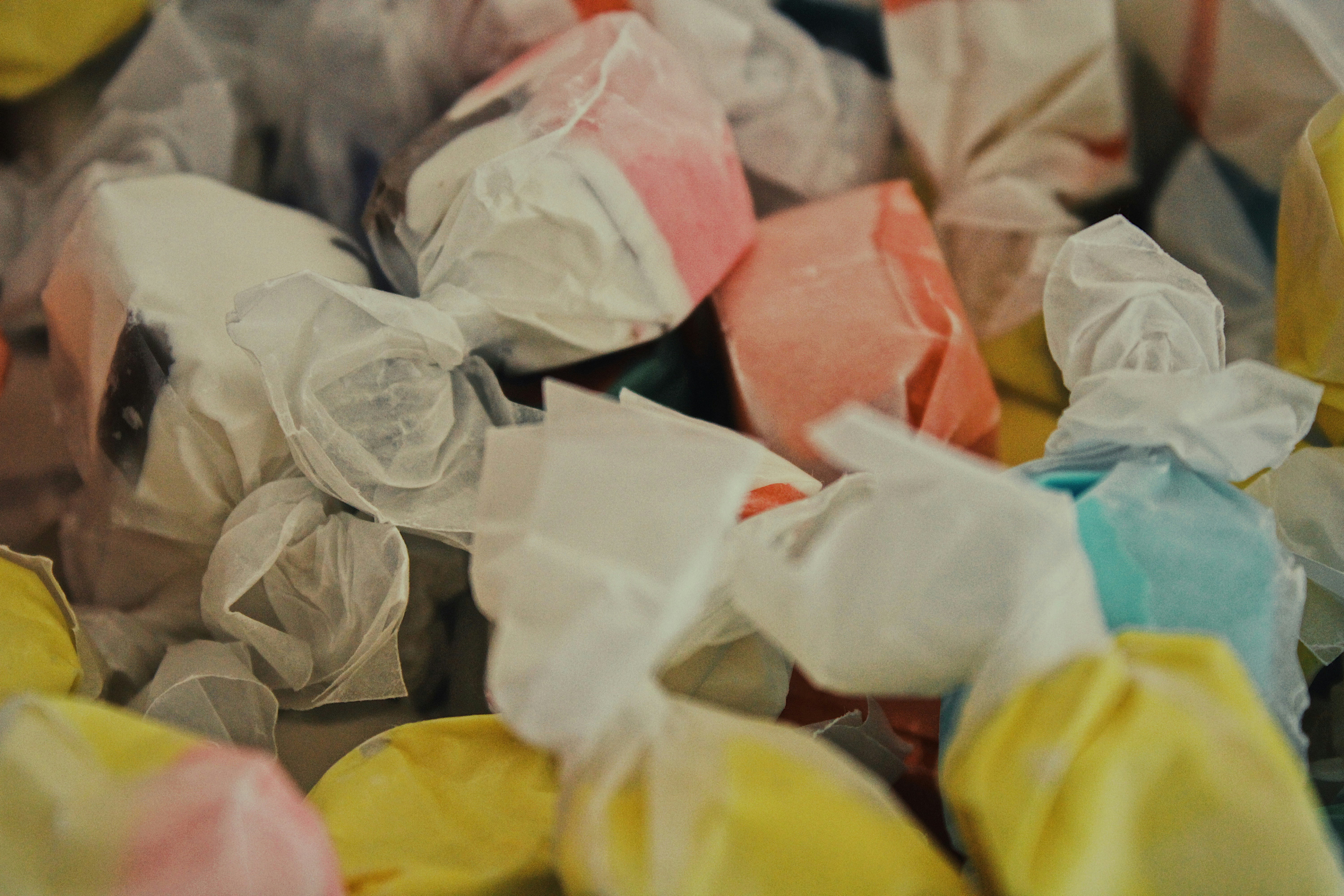 white and pink paper on yellow textile